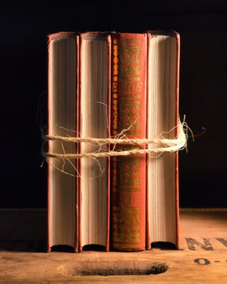 Image of four books tied together with twine