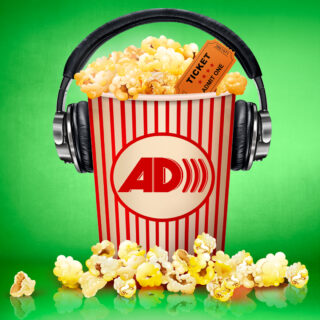 Overflowing bucket of popcorn with headphones on