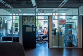 looking through a glass office door with people inside